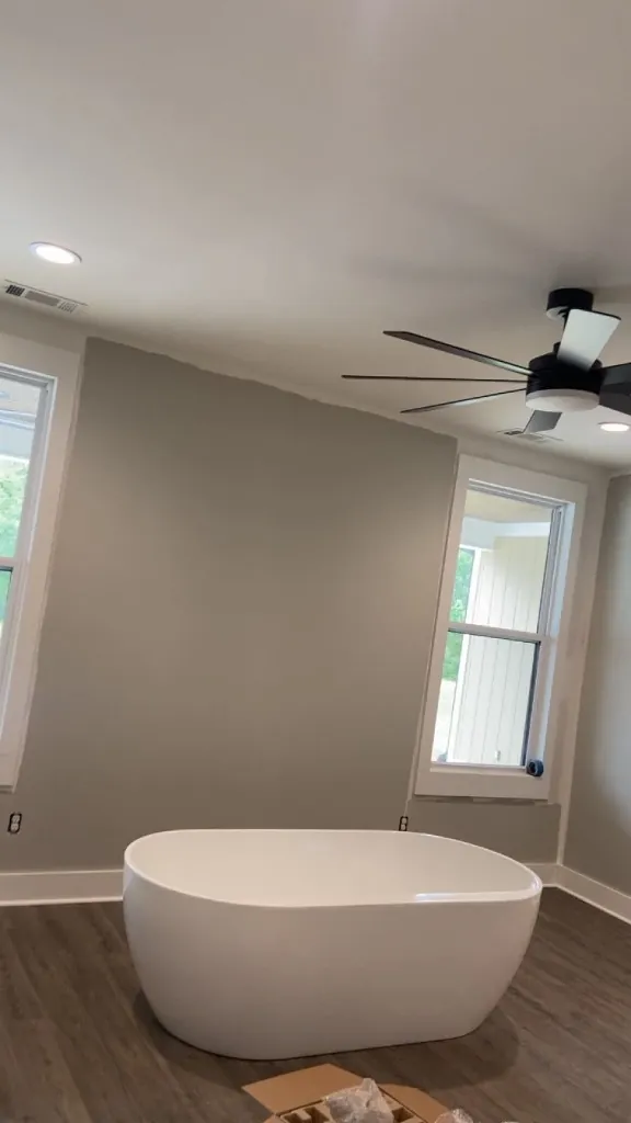 Finished master bathroom with freestanding tub and smooth drywall