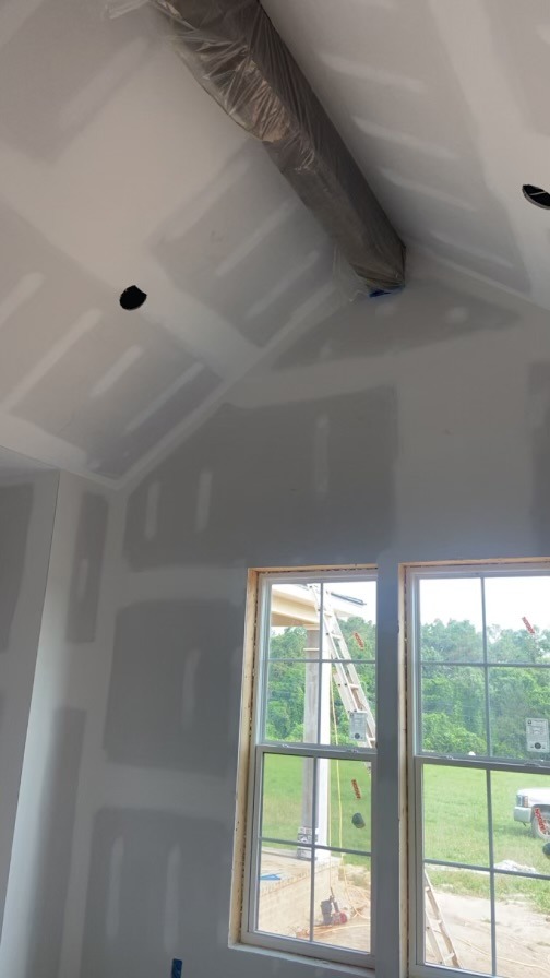 Vaulted ceiling sheetrock and mudding under construction